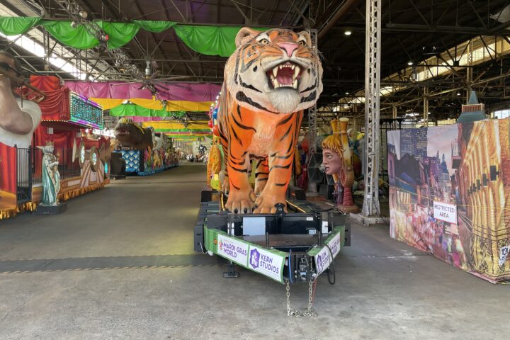 The iconic Mardi Gras Mike float on display in the Mardi Gras World float den.