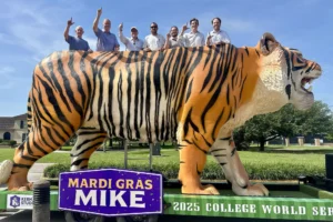 People standing on top of the Mardi Gras Mike float in Omaha, Nebraska.