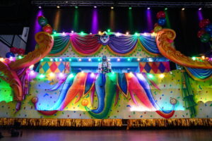 A Tulane football player stands on an illuminated Mardi Gras float